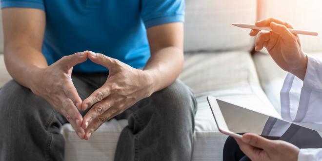 a nervous man listening to his doctor